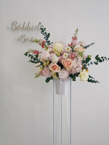 Elegant opening floral arrangement with pastel-colored roses and greenery.